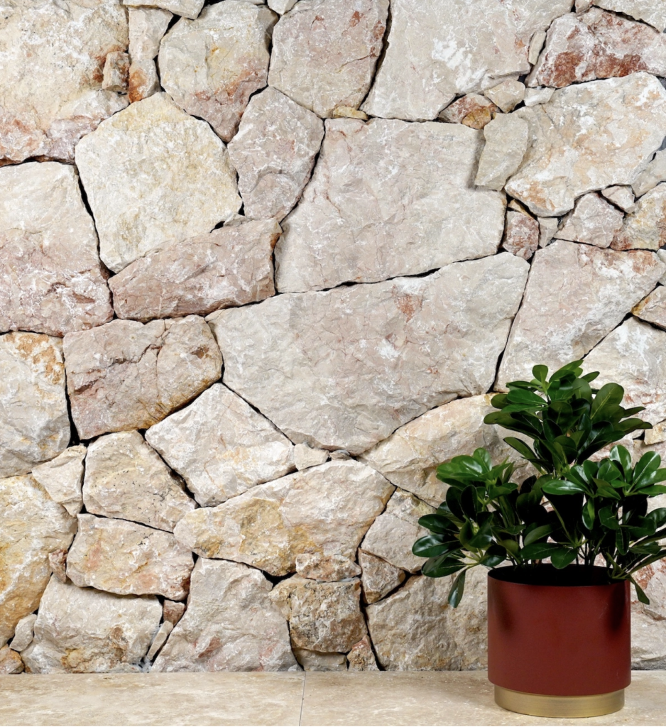 Crazy paving natural stone wall cladding in cream and honey tones above a stone-look tiled floor